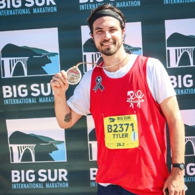 Team Move For Hunger runner, Tyler, with medal after Big Sur marathon.